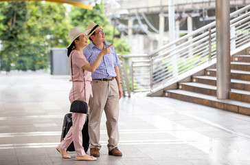 elderly couple traveler in city