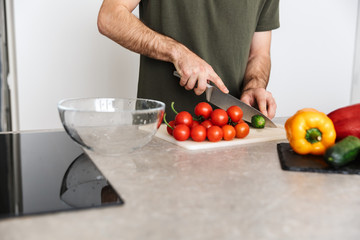 Young handsome man cooking at the kitchen at home have a breakfast.