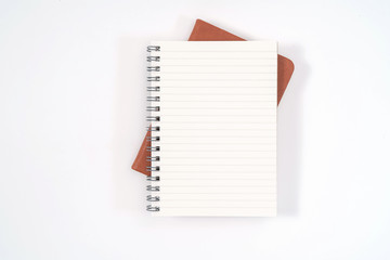 top view blank orange leather diary and pencil on white desk