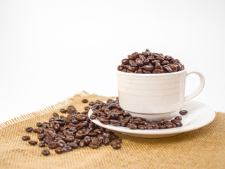 cup of coffee with beans on white background