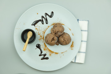 Three scoops of dark chocolate ice cream sundae