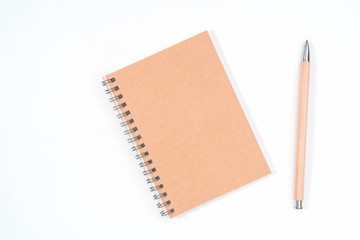 Top view blank Wood color diary and pencil on white desk