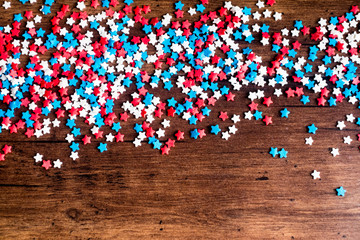 American Independence day background with blue, white and red mixed stars. Celebration of American independence day, the 4th of July (the Fourth of July). Holiday concept. Top view. With copy space. 