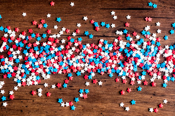 American Independence day background with blue, white and red mixed stars. Celebration of American independence day, the 4th of July (the Fourth of July). Holiday concept. Top view. With copy space. 