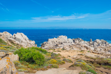 Fototapeta na wymiar Rocky coast of the island of Sardinia in the Mediterranean Sea in sunlight in spring