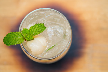 Iced drink lychee mix soda on wooden background
