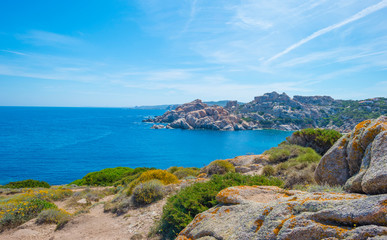 Rocky coast of the island of Sardinia in the Mediterranean Sea in sunlight in spring