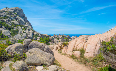 Rocky coast of the island of Sardinia in the Mediterranean Sea in sunlight in spring