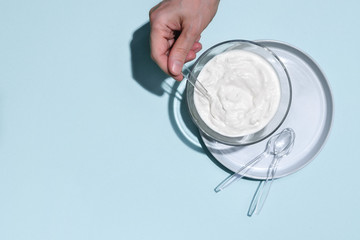 Probiotic or conventional plain yogurt in glass bowl