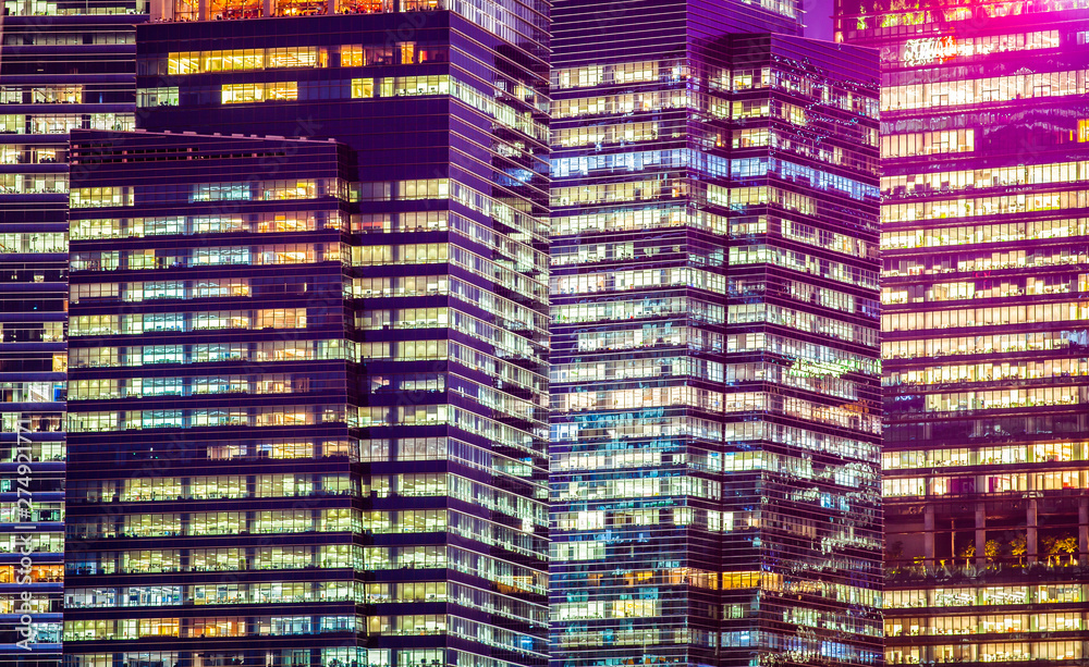 Wall mural background of skyscrapers windows at night