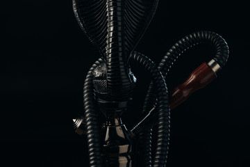 black hookah stem and hose isolated on black