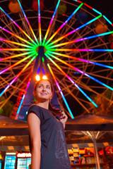Obraz premium Beautiful young woman resting in an amusement Park. Concept of summer festivals, recreation and entertainment. Close up