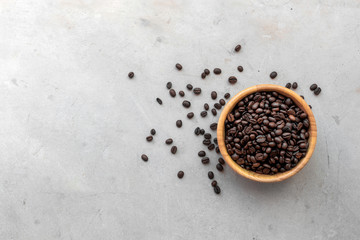 coffee bean in wooden cup on desk background