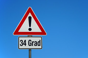 34 Grad mit Achtung Schild