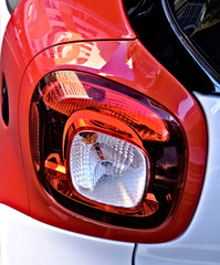 Combined rear position lamps, detail of modern automotive streamlined lighting, black car.