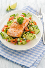 Grilled salmon fillet with vegetable salad.