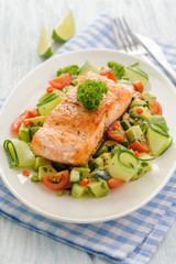 Grilled salmon fillet with vegetable salad.