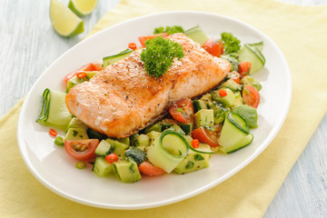 Grilled salmon fillet with vegetable salad.