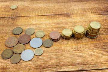 coins old euro replaced by new Europe euro pile pack heap on a wooden background mock up selective focus close up