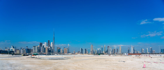 Fototapeta na wymiar Wide panorama of Dubai cityscapes with Burj Khalifa at daytime