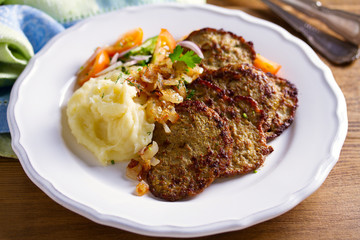 Beef liver pancakes with mashed potato and vegetables. Liver side dish
