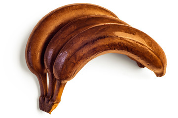 Rotten banana from the fridge, spoiled fruits. Isolated on white background. Darkened banan. Drops...