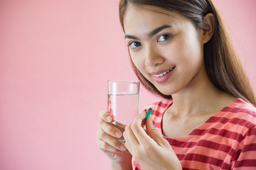 Young woman taking medicine pill after doctor order