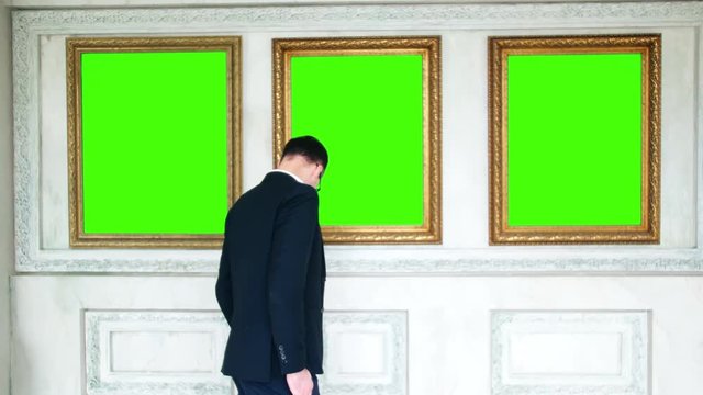 Back view of art critic visiting new exhibition in museum