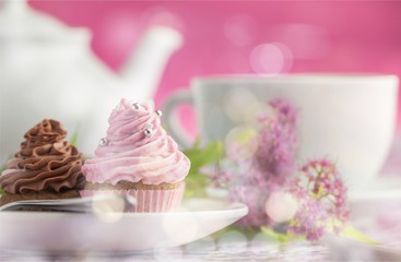 Delicious cupcakes with cream and tea set
