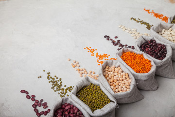 red and white beans, red lentils, soybeans, peas in bags on a white background. keto diet  Natural foo