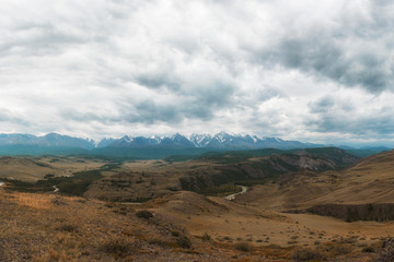 Fototapeta na wymiar Summer in Kurai steppe and North-Chui ridge of Altai mountains, Russia. Cloud day.