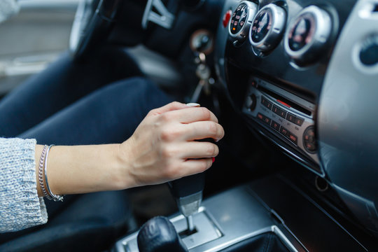 Woman switches the automatic transmission's close-up. Close-up of the driver's adm includes mode Drive on the gear lever automatic transmission of the car interior parts