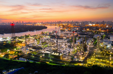 Naklejka premium Aerial view of twilight of oil refinery ,Shot from drone of Oil refinery and Petrochemical plant at dusk , Bangkok, Thailand