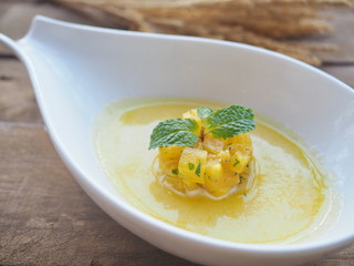 Cold refreshing sweet sour diced tropical summer pineapple cube coconut gazpacho soup with mint...