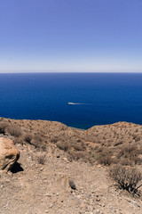 Fototapeta na wymiar Ship sailing through the ocea, elevated shot from the mountain top. Gran Canaria, Spain. 