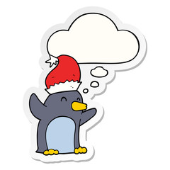 cute cartoon christmas penguin and thought bubble as a printed sticker