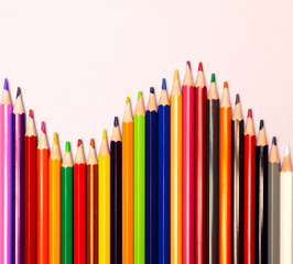 Сolored pencils isolated on colored background. Close up