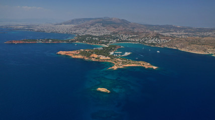 Obraz premium Aerial drone photo of famous luxurious Lemos peninsula in Vouliagemeni area with iconic celebrity sandy beach of Asteras, Athens riviera, Glyfada, Attica, Greece