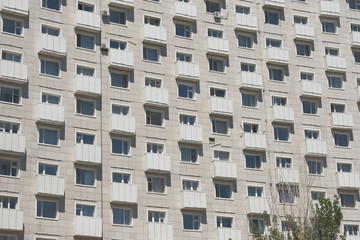 facade of a white apartment building with balconies