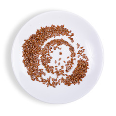 flax seeds in plate on white background isolation