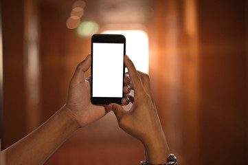 Smartphone mockup on hands with blur background.