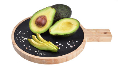 Composition of ripe fresh avocados, spices and wooden cutting board on a neutral white background