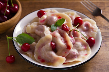 Dumplings, filled with cherries. Varenyky, vareniki, pierogi, pyrohy - dumplings with filling