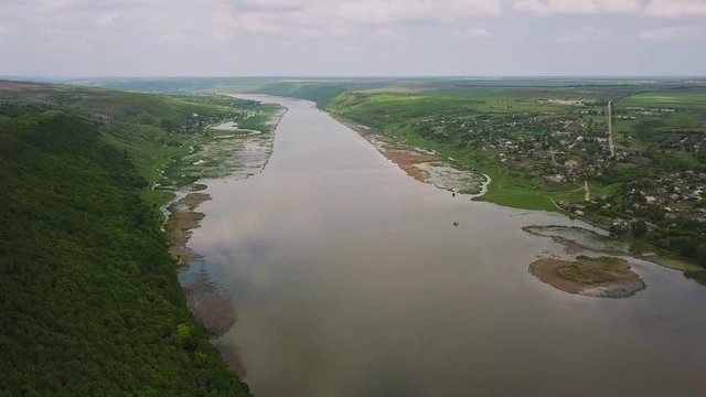Flying over the river on a sunny summer day. Dniester river of Moldova republic.