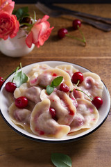 Dumplings, filled with cherries. Varenyky, vareniki, pierogi, pyrohy - dumplings with filling
