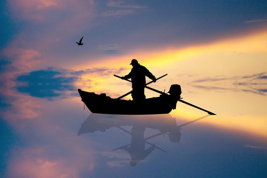 fisherman on the boat at sunset