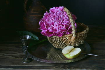 Peony and a piece of Apple on a metal tray.