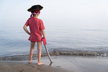 Pirate child looks towards the sea