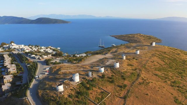 Flying over windmills in Bodrum, Turkey. Spectacular picture at sunset. Welcome to Turkey concept. Aerial 4k