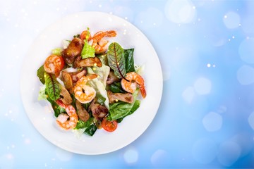 Green salad with shrimps on background
